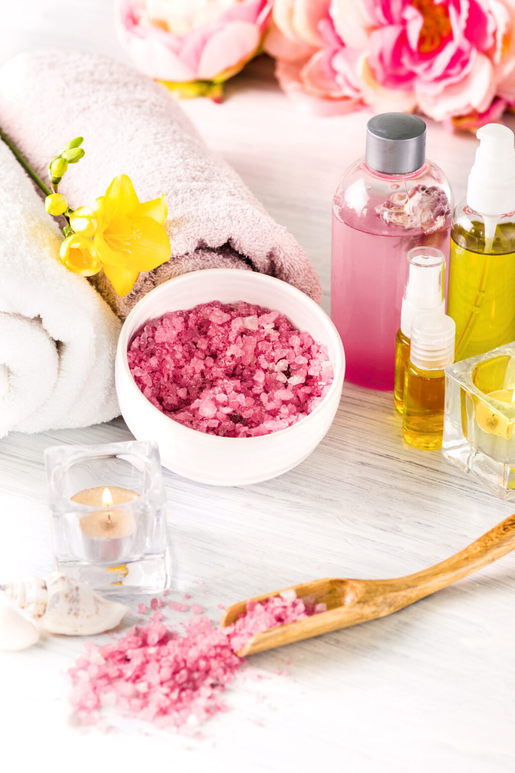 Spa setting with pink roses, sea salt and aroma oil, vintage style